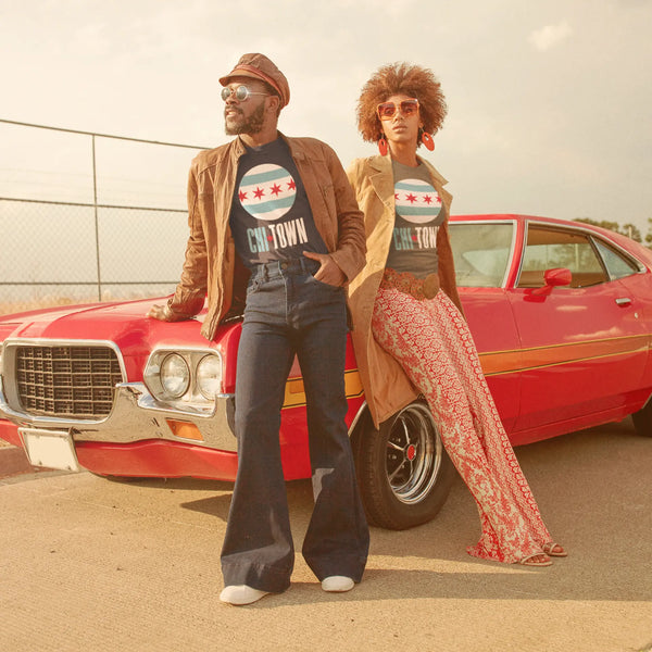 Stylish couple by a red muscle car rocking a ring-spun cotton Chi-town T-shirt!