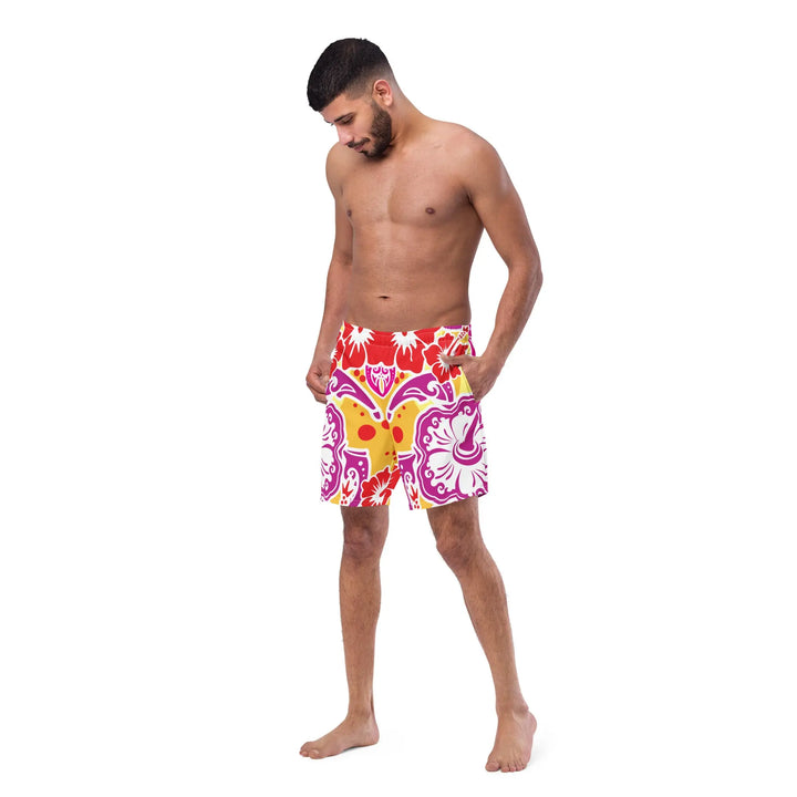 Shirtless man in colorful Hawaii Blossoms Retro board shorts soaking up the sun