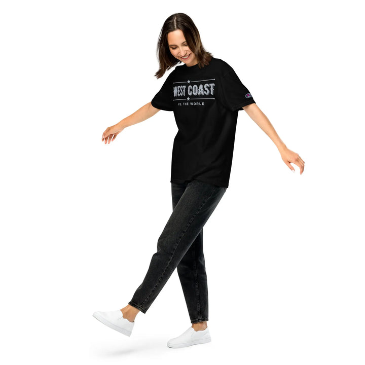 Woman in black West Coast t-shirt & dark jeans from WEST COAST VS. THE WORLD premium brand